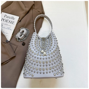 Detail of lavender bucket bag with shimmering rivets and pearl drawstring accents