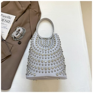 Detailed top view of light grey bucket bag with silver rivets, rhinestones and metal chain