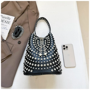 Detail of black lychee leather bucket bag with silver studs and pearl chain drawstring