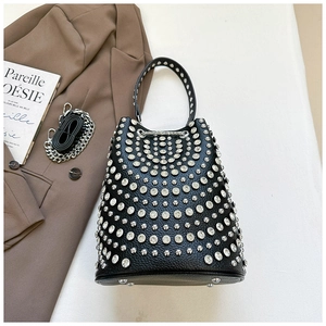 Detail of black leather rivet bucket bag with silver studs and chain strap