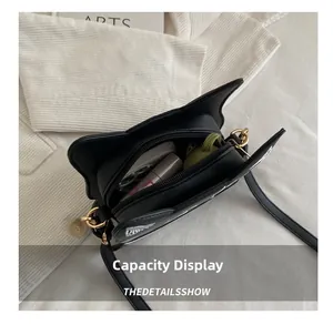 Top view of cat-ear crossbody bag showing spacious interior for cosmetics and accessories
