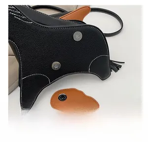 Close-up of litchi grain leather texture with white contrast stitching and magnetic buckle