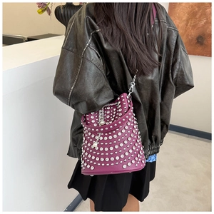 Detailed close-up of purple bucket bag featuring silver rivets and metallic chain strap