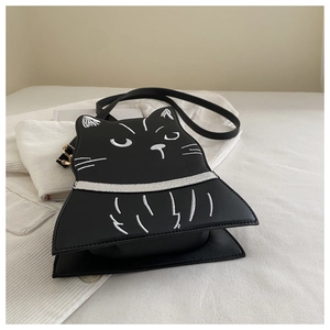 Detail of embroidered cat face and bowknot accent on the black round crossbody bag