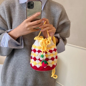 Handmade crochet strawberry bucket bag with colorful knit daisy patterns and drawstring