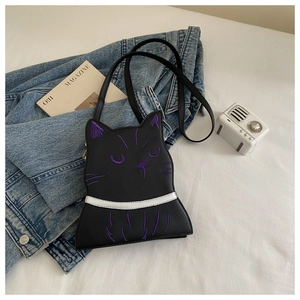 Detail of cute cat crossbody bag with purple embroidery and silver collar accents