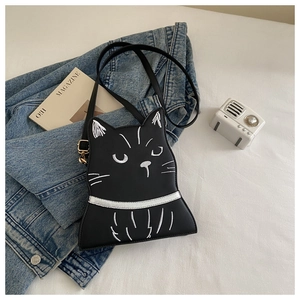 Detailed embroidery of a cute black cat face on a round PU leather crossbody handbag