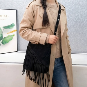 Chic black faux suede crossbody bag with long fringe and silver studded strap