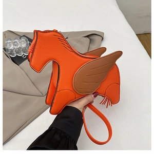 Detail of orange pegasus crossbody bag with lychee texture leather and wing decor