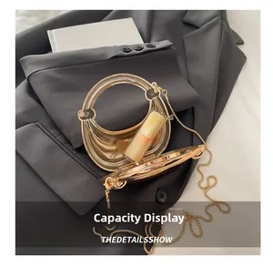 Detail view of gold crescent evening bag interior showing capacity for a lipstick