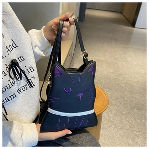 Detail of cat shaped crossbody bag with purple face embroidery and slim shoulder strap