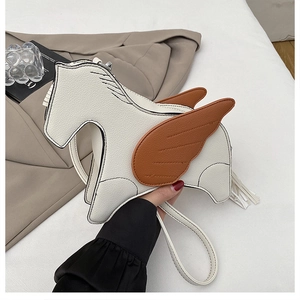 Close-up of Pegasus animal shaped crossbody bag with brown wings and white fringe detail