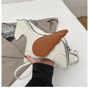 Close-up of pebble texture PU leather on pony shaped crossbody bag with brown wing detail