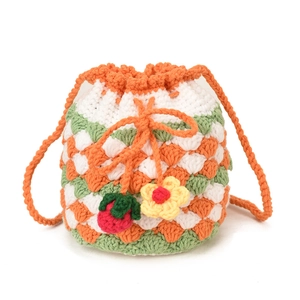 Handmade crochet strawberry drawstring bucket bag with floral knit pattern and tassels