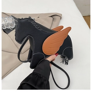 Close-up of leather pony shaped crossbody bag with brown wings and white stitching details