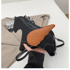 Detail of creative horse-shaped crossbody bag with black leather and brown wings