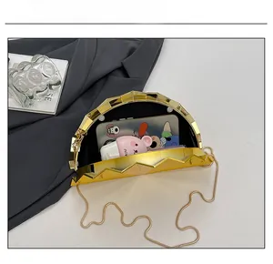 Detail showing the internal capacity of a golden fan-shaped evening clutch bag