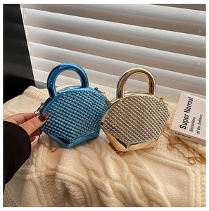 Detail of blue and gold beaded shell bags with round handles and gold chain straps