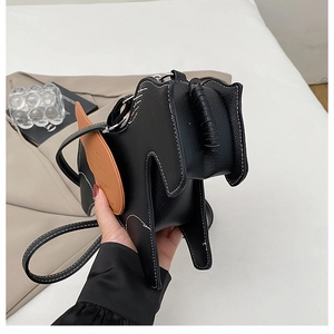 Detail of horse-shaped crossbody bag featuring white contrast stitching and brown wings