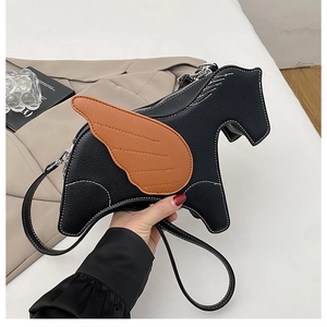 Close-up of black Pegasus shaped crossbody bag with brown wing detail and white stitching