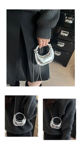 Silver mirror crescent chain bag shown as both a handbag and crossbody clutch