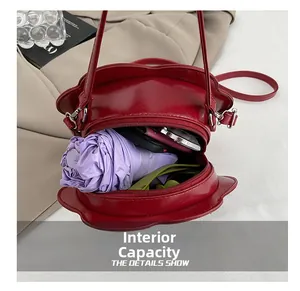 Internal capacity of red flower shaped bag with umbrella, wallet and phone