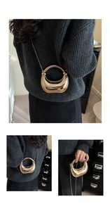 Detailed views of gold crescent moon acrylic evening bag with metallic chain strap