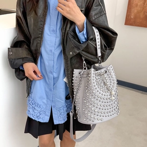 Grey rivet bucket bag with silver studs and pearl charms shown on female model