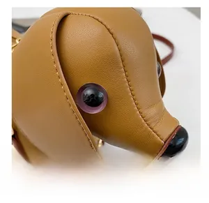 Close-up of stitching and eye detail on a creative dachshund shaped leather bag