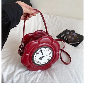 Detailed view of dark red vintage clock-shaped round handbag with roman numerals dial