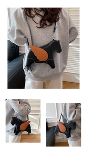 Detail view of Pegasus shaped crossbody bag featuring white stitching and brown wings