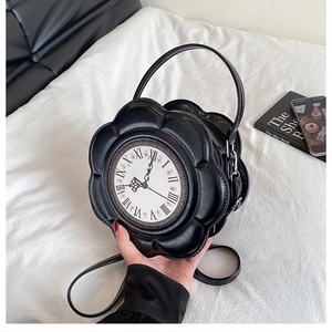 Close-up of creative floral clock bag in black PU leather with roman numeral dial