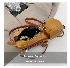 Detail view showing internal capacity of the dog-shaped shoulder bag with daily items