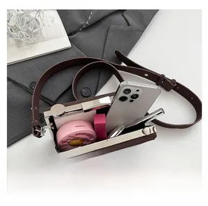 Detail view of brown vintage camera bag showing interior storage for phone and makeup