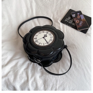 Macro detail of a black flower-shaped PU leather handbag featuring a vintage clock face dial