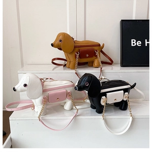 Detail of dachshund puppy shoulder bag showing top zipper and metal chain strap in three colors