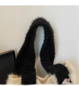 Detail of soft black plush handle and cream knit texture on this stylish tote bag