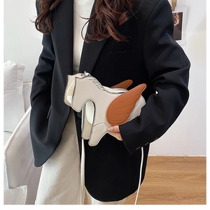 Whimsical pegasus crossbody bag in cream and brown leather shown on a model