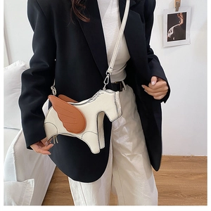 Detailed view of creative pegasus shaped crossbody bag in white and brown leather