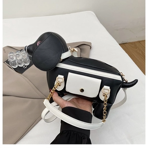 Détail du sac à bandoulière en forme de chien avec sangle blanche et dorure