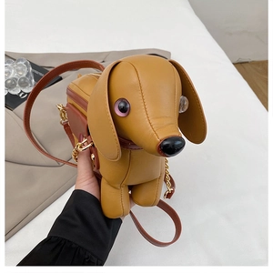 Detailed close-up of a creative dachshund-shaped crossbody bag in warm yellow faux leather