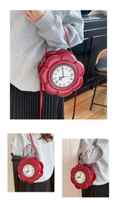 Close-up of the vintage clock dial and red floral-shaped PU leather handbag texture