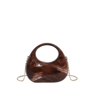 Amber marble acrylic crescent handbag with gold chain strap and integrated ring handle