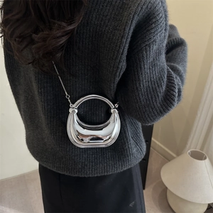 Silver crescent acrylic mini bag with circular handle and chain strap for evening events
