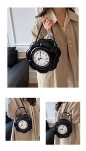 Detail of creative black flower-shaped clock handbag with vintage Roman numerals dial
