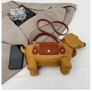 Detail of creative mustard yellow dog shaped PU leather bag with top handles and strap