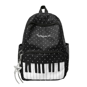Polka dot music backpack with piano key design and star charm on white background