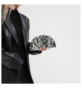 Detail of silver shell clutch with ice crack pattern and metallic mirror finish