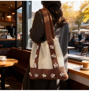 Detailed knit tote bag showing intricate brown and white floral pattern craftsmanship