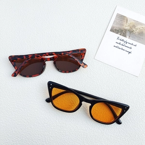 Vintage cat eye sunglasses with leopard and black frames featuring metallic rivet details